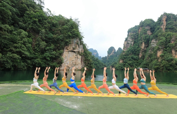 On Yoga Day, Practitioners pose near the waters of Baofeng Lake